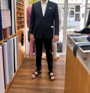 Customer wearing a navy custom wedding suit with a white dress shirt at a bespoke tailor in Sukhumvit 33, Bangkok
