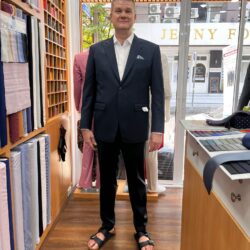 Customer wearing a navy custom wedding suit with a white dress shirt at a bespoke tailor in Sukhumvit 33, Bangkok