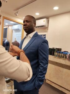 Customer trying on a custom tailored jacket during fitting