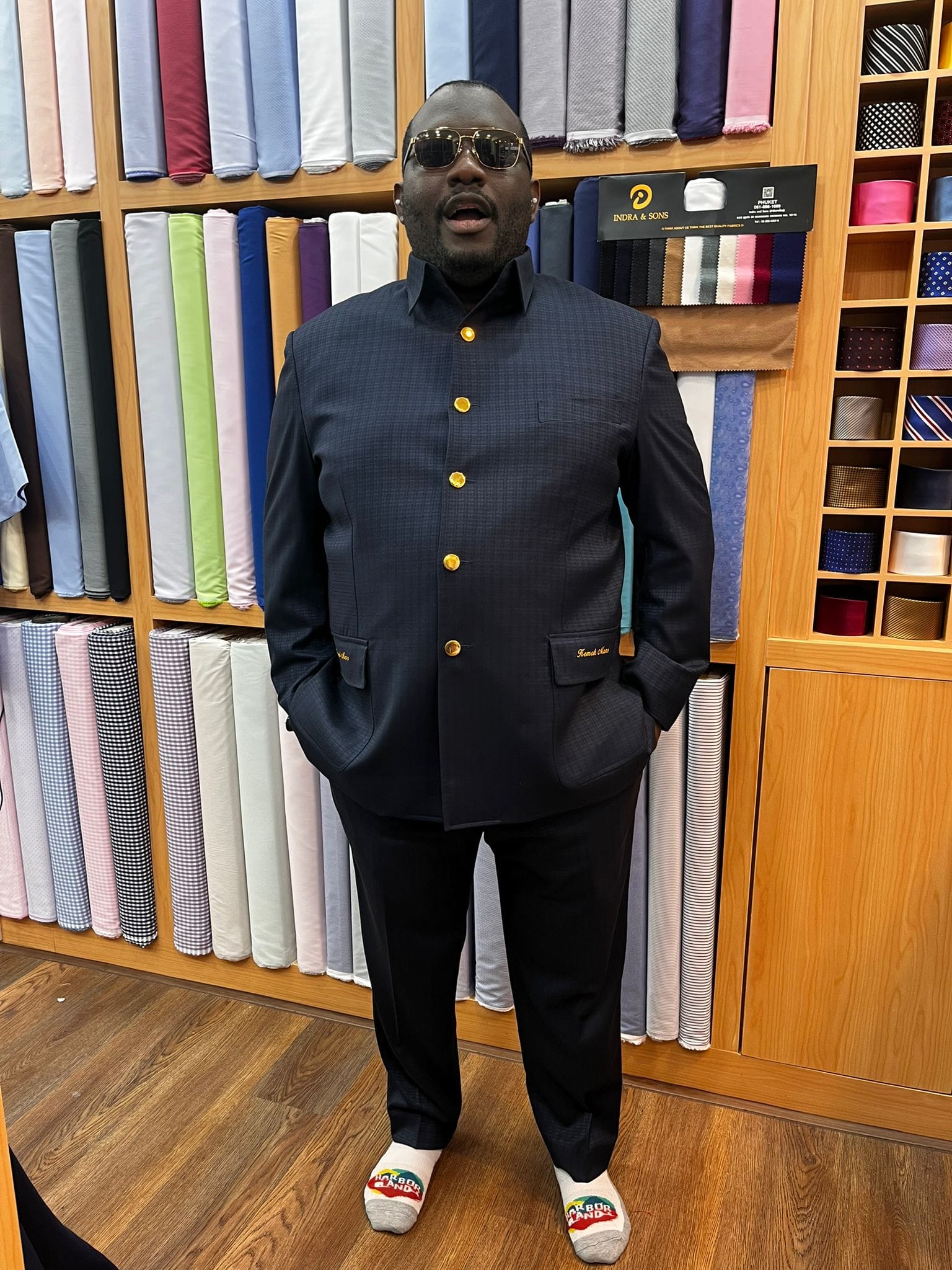 Customer wearing a navy asian style custom wedding suit with a white dress shirt at a bespoke tailor in Sukhumvit 33, Bangkok