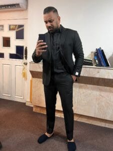 Customer wearing a black custom wedding suit with a white dress shirt at a bespoke tailor in Sukhumvit 33, Bangkok