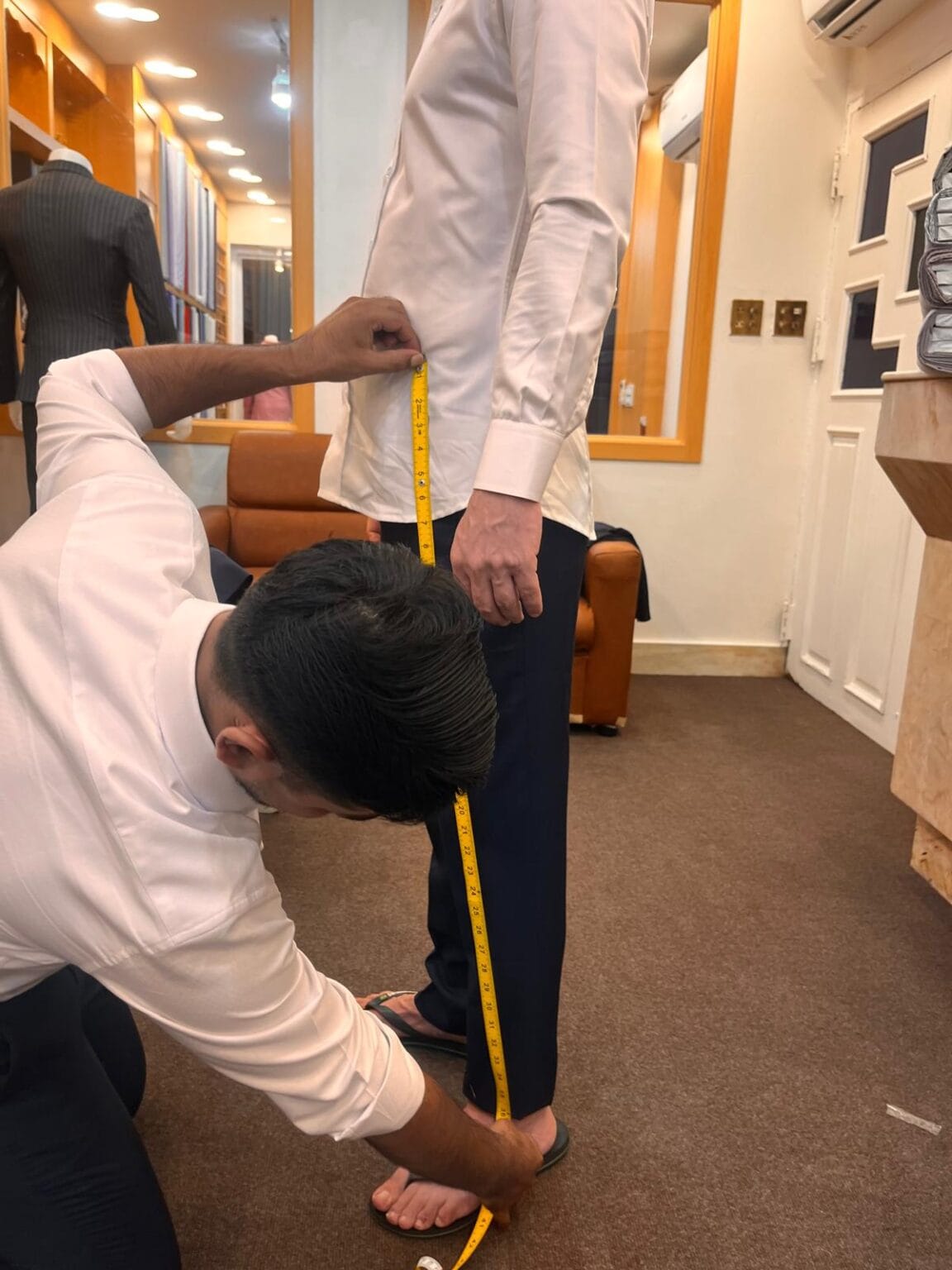 Customer Getting measured in Velour & Waza Custom Tailor